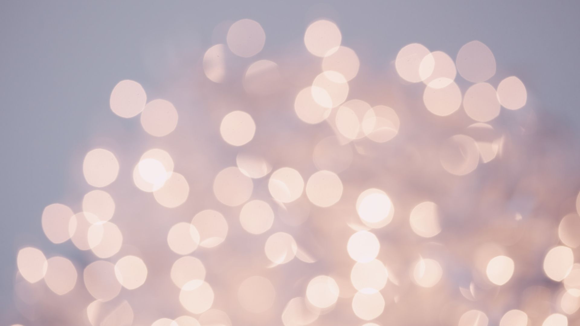 The image displays a blurred or bokeh effect of white and pink lights on a soft, blurry background, creating a dreamy and ethereal atmosphere.