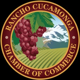 A circular logo for the Rancho Cucamonga Chamber of Commerce featuring grapes, a vineyard, and mountains with a maroon and gold border.