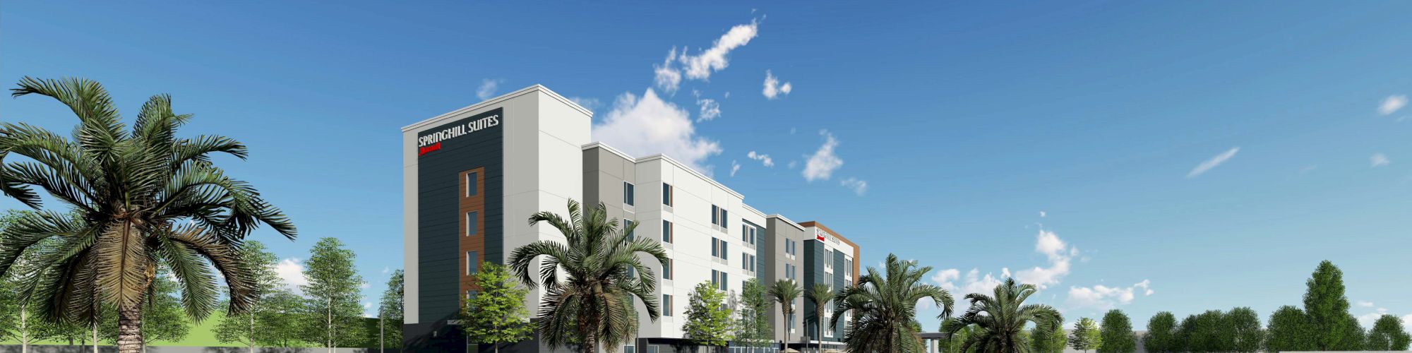 A modern multi-story hotel with palm trees, cars, and people walking along the street on a sunny day.